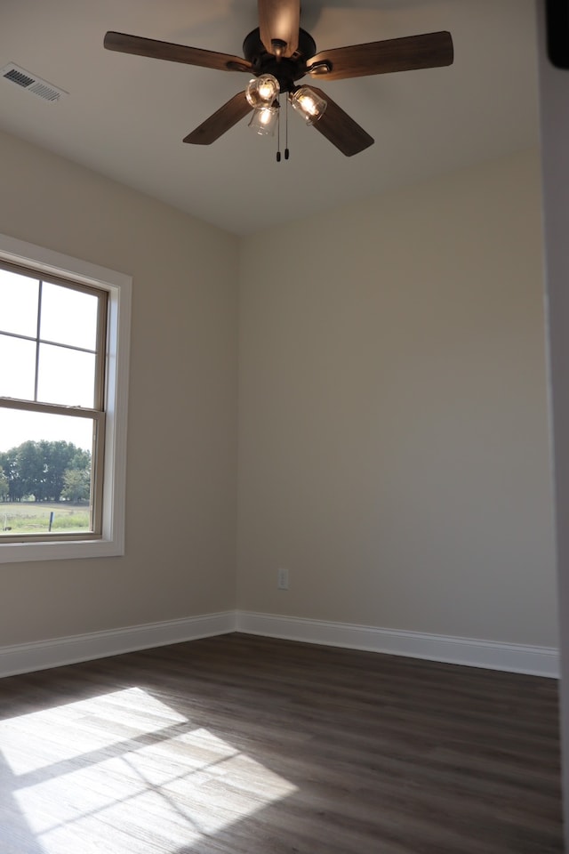 empty room featuring ceiling fan and dark hardwood / wood-style floors