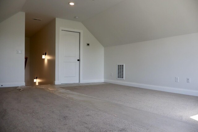 bonus room with carpet and vaulted ceiling