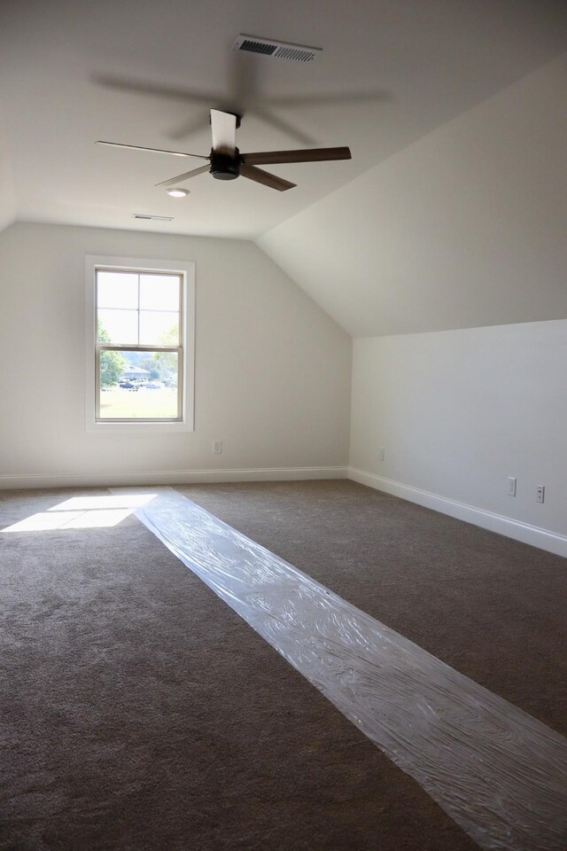 additional living space featuring lofted ceiling, ceiling fan, and carpet flooring