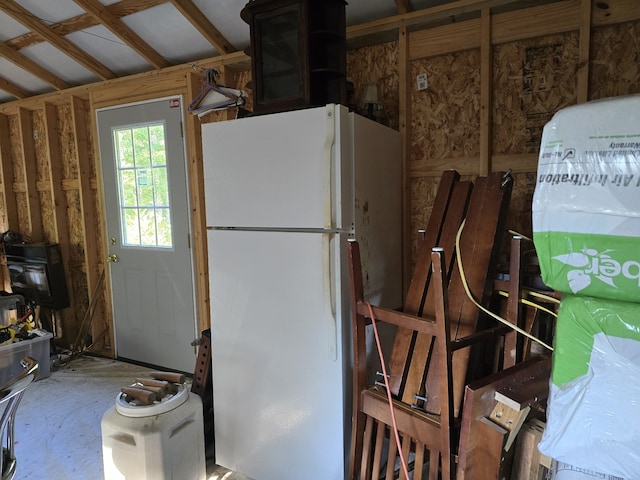 kitchen with vaulted ceiling and white refrigerator