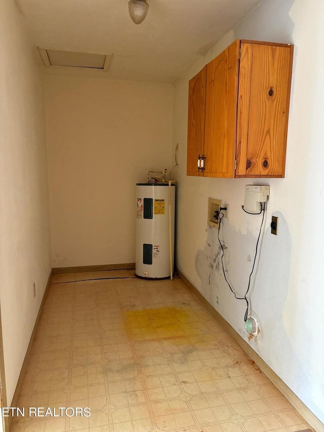 laundry area featuring electric water heater, cabinet space, light floors, attic access, and hookup for a washing machine