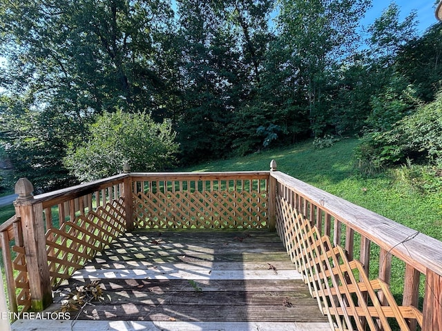 wooden terrace with a yard