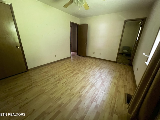 unfurnished bedroom with light wood-type flooring, baseboards, visible vents, and a ceiling fan