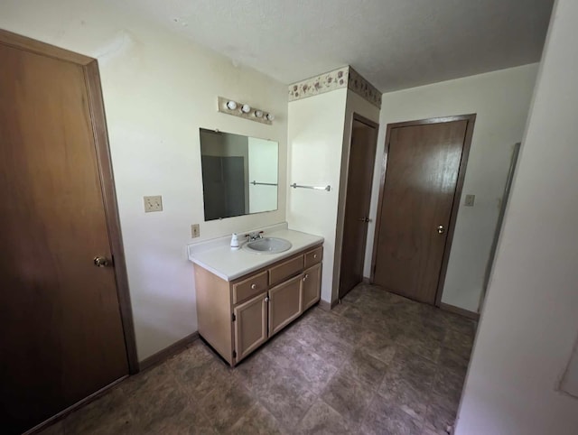 bathroom featuring vanity and baseboards