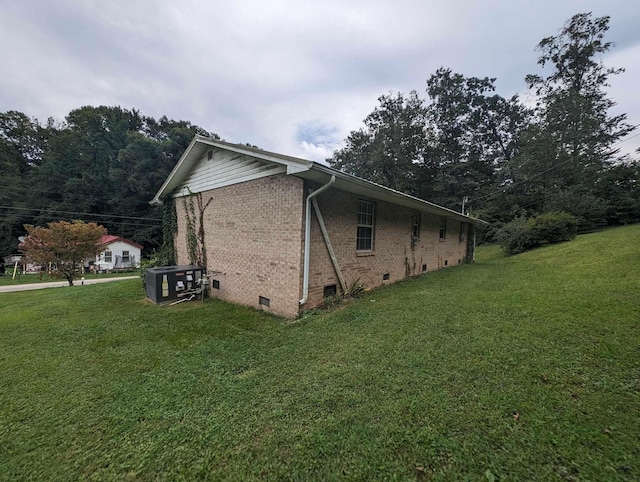 view of property exterior with a lawn, brick siding, and crawl space