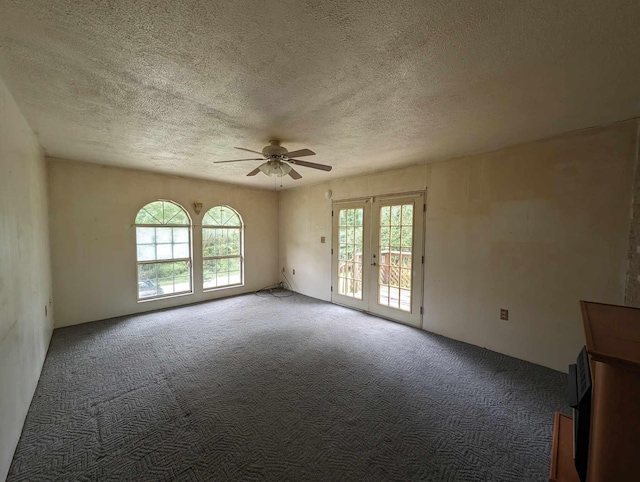 empty room with carpet, a textured ceiling, french doors, and a ceiling fan