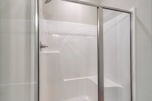 bathroom with a shower with door