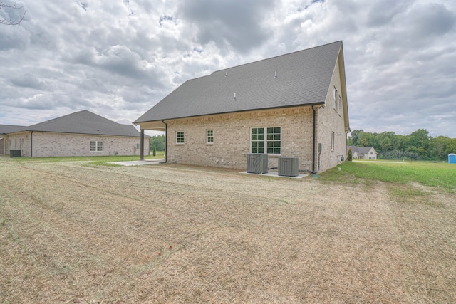 back of house featuring central AC unit and a patio area