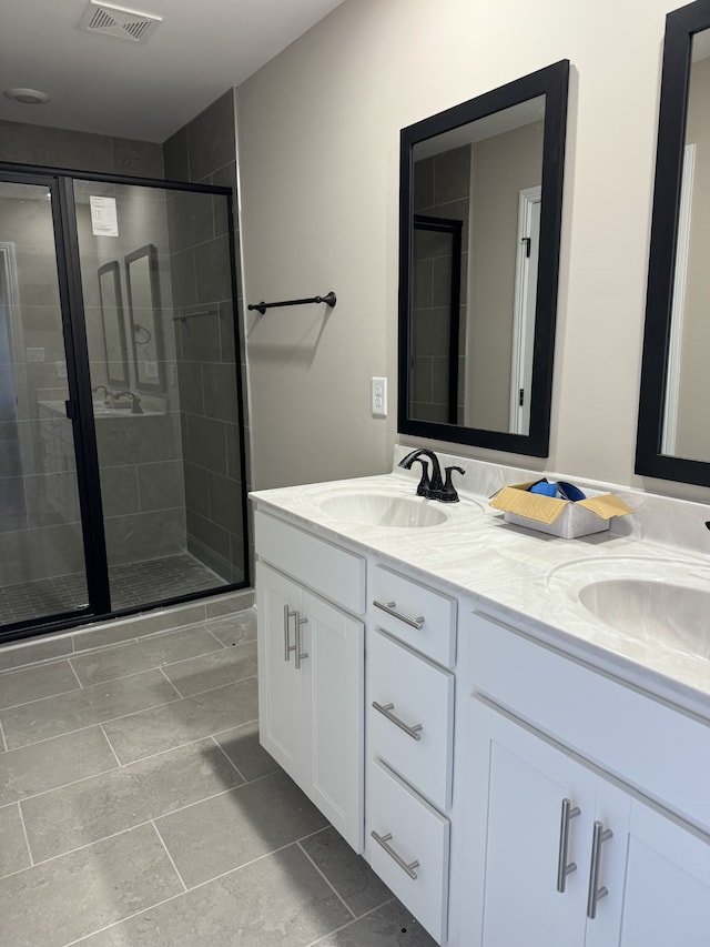 bathroom featuring vanity and a shower with shower door