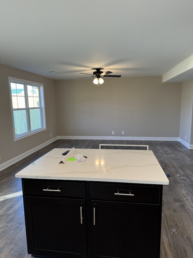 kitchen featuring a kitchen island, dark wood-type flooring, and ceiling fan