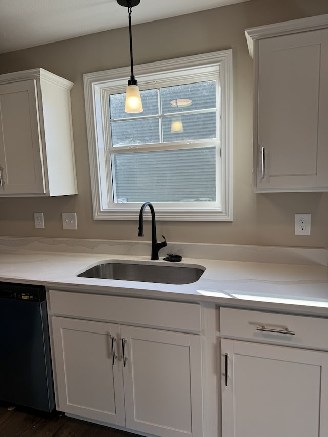 kitchen with white cabinetry, sink, pendant lighting, and dishwasher