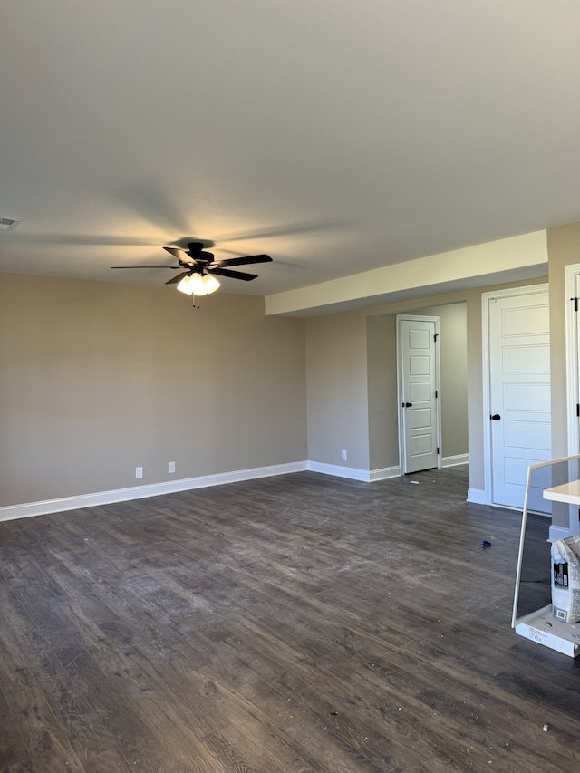 empty room with dark wood-type flooring and ceiling fan