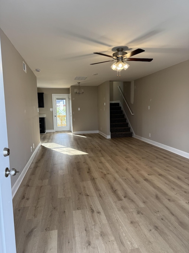 unfurnished living room with hardwood / wood-style floors and ceiling fan