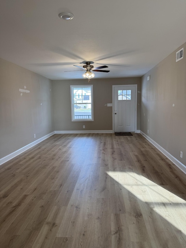 foyer entrance with light wood-type flooring and ceiling fan