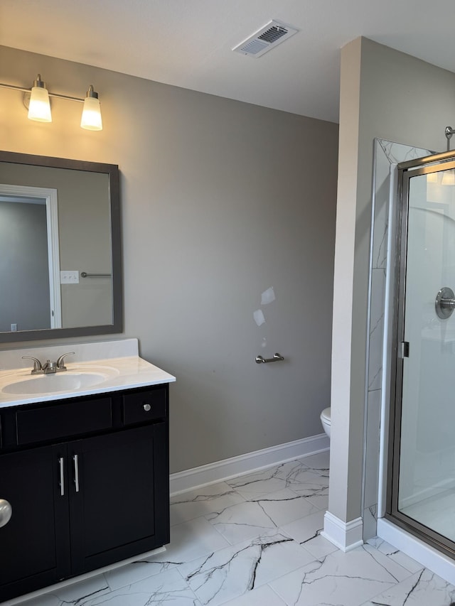 bathroom featuring vanity, toilet, and an enclosed shower