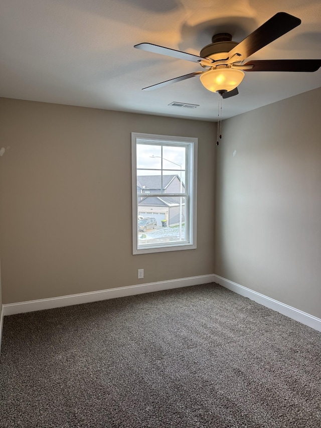 empty room with ceiling fan and carpet floors