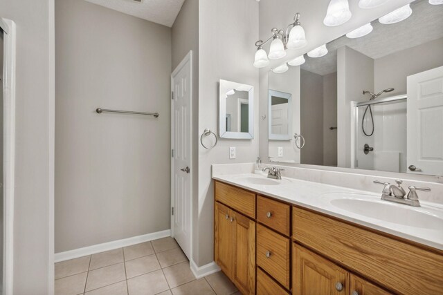 bathroom featuring dual vanity, a textured ceiling, and tile patterned floors