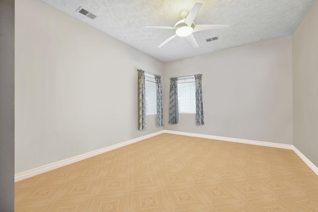 empty room with a textured ceiling and ceiling fan