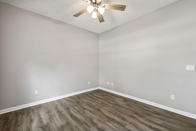 empty room with ceiling fan, dark hardwood / wood-style flooring, and a textured ceiling