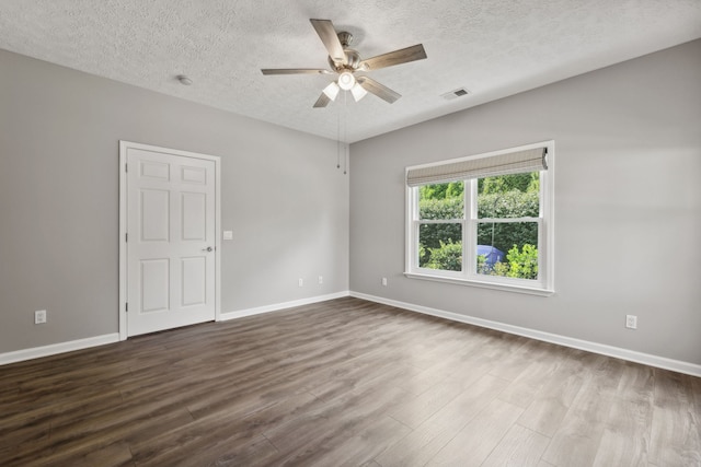 spare room featuring wood-type flooring, a textured ceiling, and ceiling fan