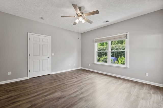 empty room featuring hardwood / wood-style flooring, a textured ceiling, and ceiling fan