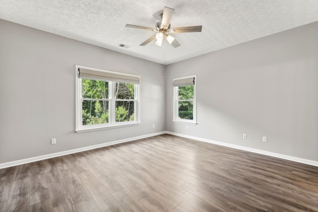 spare room with a textured ceiling, ceiling fan, and hardwood / wood-style floors