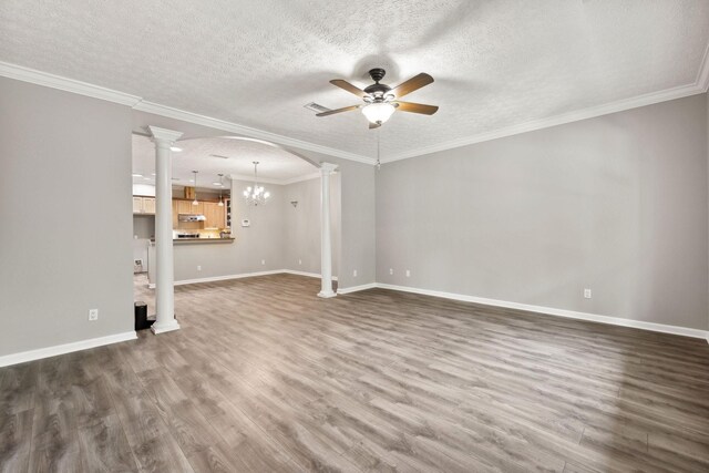 unfurnished room with ceiling fan with notable chandelier, wood-type flooring, and ornamental molding