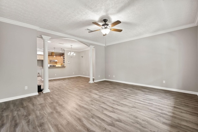 unfurnished living room featuring dark hardwood / wood-style flooring, ceiling fan with notable chandelier, crown molding, and ornate columns