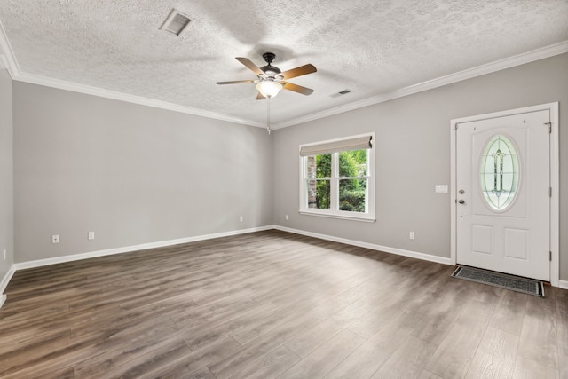 foyer featuring hardwood / wood-style floors, a textured ceiling, ornamental molding, and ceiling fan