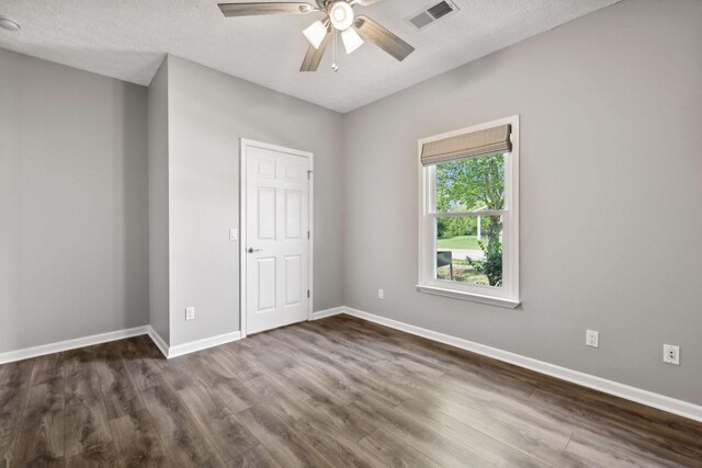 unfurnished bedroom with hardwood / wood-style flooring, a textured ceiling, and ceiling fan