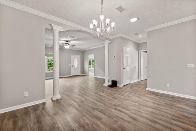 unfurnished living room with decorative columns, wood-type flooring, ceiling fan, crown molding, and a textured ceiling