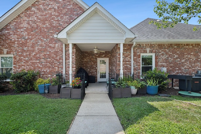 exterior space featuring ceiling fan and a lawn