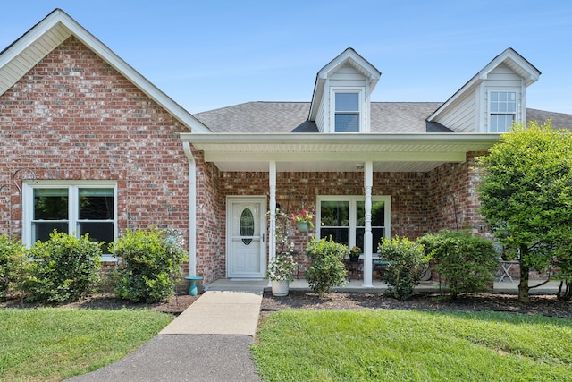 view of front of home featuring a porch and a front lawn