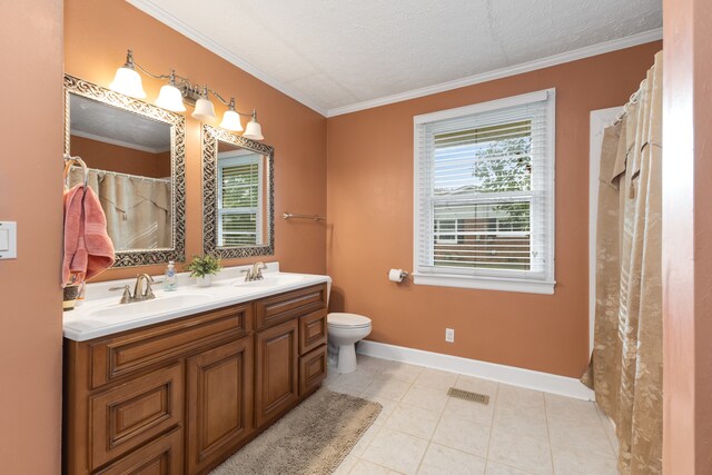 bathroom with plenty of natural light, toilet, double vanity, and tile patterned floors