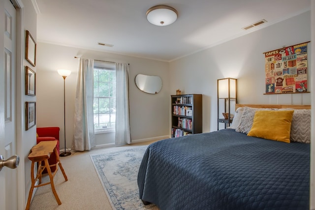 carpeted bedroom featuring crown molding