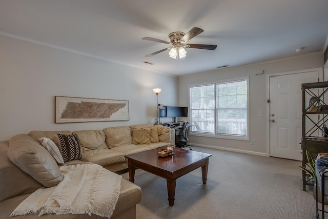 carpeted living room with ornamental molding and ceiling fan