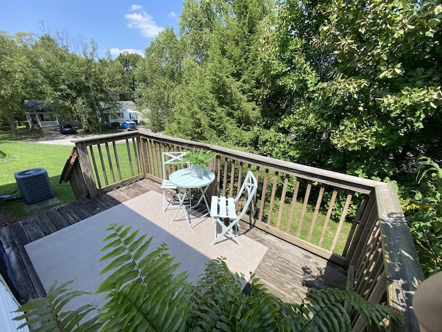 deck featuring central air condition unit and a lawn