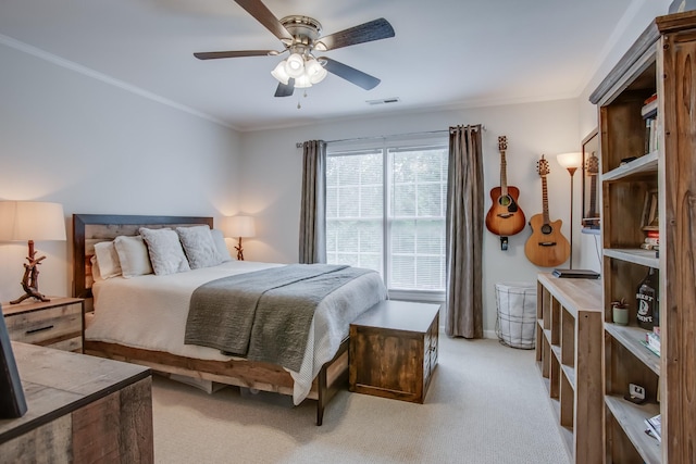 carpeted bedroom featuring crown molding and ceiling fan