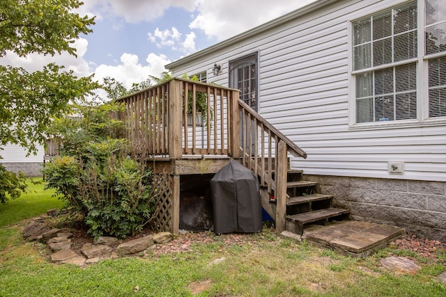 exterior space featuring a lawn and a deck