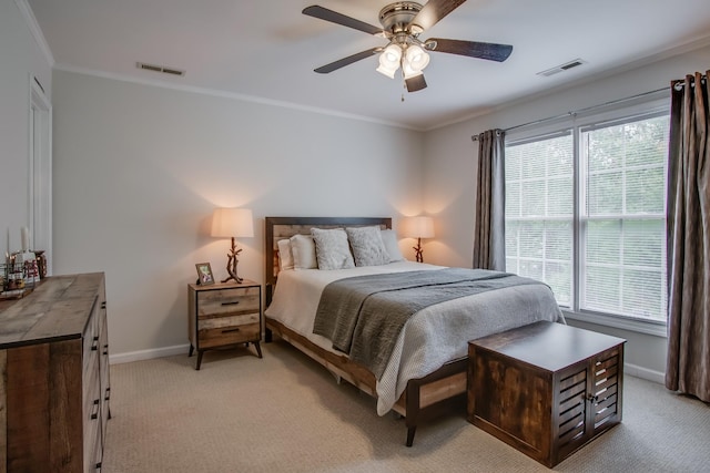 bedroom with multiple windows, ornamental molding, and light carpet