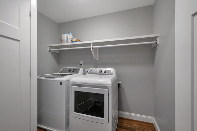 laundry area featuring separate washer and dryer and wood-type flooring