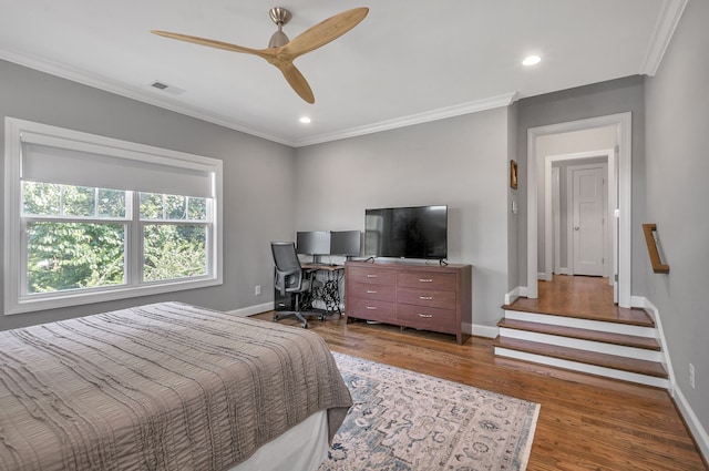 bedroom with ceiling fan, crown molding, and wood-type flooring