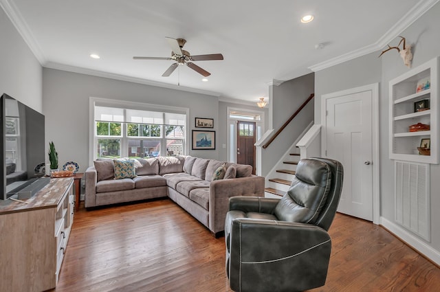 living room featuring ceiling fan, dark hardwood / wood-style flooring, and crown molding