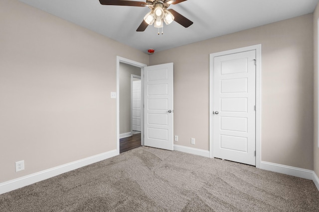 unfurnished bedroom featuring ceiling fan and carpet flooring