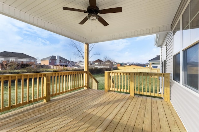 deck featuring ceiling fan and a lawn