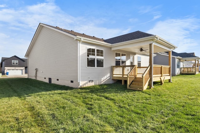 back of property with ceiling fan, a yard, and a wooden deck