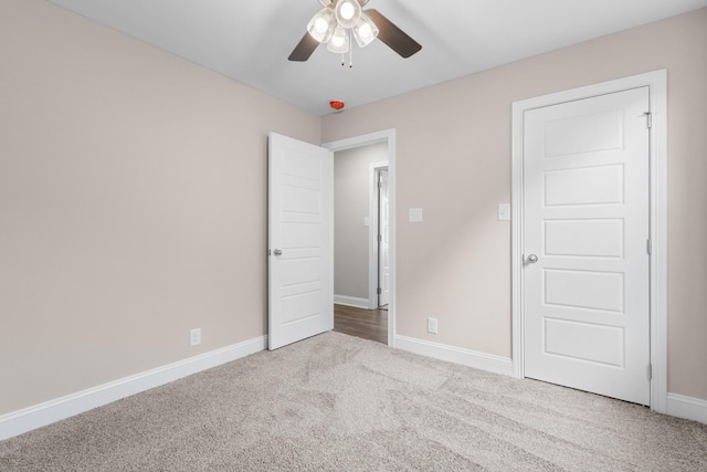 unfurnished bedroom with ceiling fan and light colored carpet