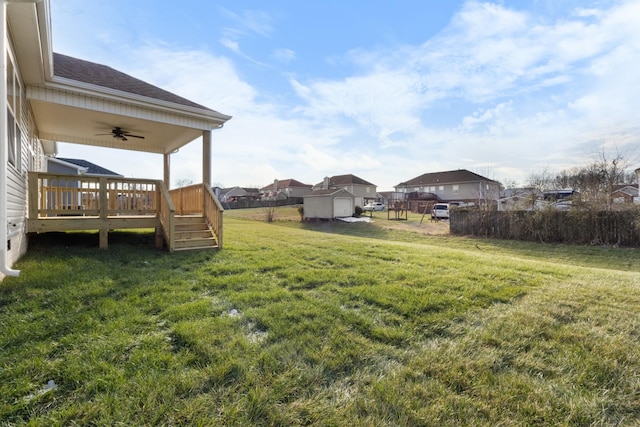 view of yard featuring ceiling fan and a wooden deck