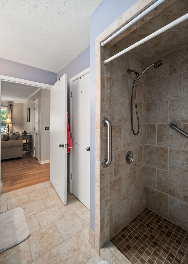 bathroom featuring a textured ceiling and hardwood / wood-style floors