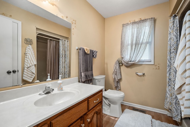 bathroom featuring vanity, toilet, and hardwood / wood-style flooring